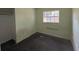 Small bedroom with window and damaged flooring at 1506 Fairbanks St, Lakeland, FL 33805