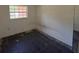 Small bedroom with window and dark flooring at 1506 Fairbanks St, Lakeland, FL 33805
