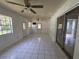 Open bonus room with tile flooring, lots of natural light, and sliding door access to backyard at 1506 Fairbanks St, Lakeland, FL 33805