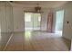 Open dining room with tiled floor, chandelier, and mirrored wall, creating a bright and inviting space at 1506 Fairbanks St, Lakeland, FL 33805