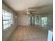 Open living room with tiled floor, a ceiling fan, and mirrored wall, creating a bright and inviting space at 1506 Fairbanks St, Lakeland, FL 33805