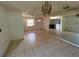 Open living room with tile floors, fan, and natural light from window at 1506 Fairbanks St, Lakeland, FL 33805