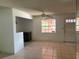 Open living room with tile floors, fan, and natural light from window at 1506 Fairbanks St, Lakeland, FL 33805