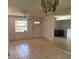 Spacious living room with tile floors, a ceiling fan, and a bright window, offering a comfortable space at 1506 Fairbanks St, Lakeland, FL 33805