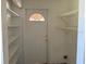 Practical utility room with shelving, a door, and basic necessities at 1506 Fairbanks St, Lakeland, FL 33805