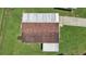 An aerial view showcases the roof and landscaping of the home at 1548 Longbow Dr, Lakeland, FL 33810