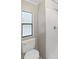 Modern bathroom with white toilet and shower stall, as well as a window for natural light at 1548 Longbow Dr, Lakeland, FL 33810