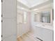 Bright bathroom featuring a modern vanity with updated sink and mirrors at 1548 Longbow Dr, Lakeland, FL 33810