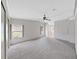 Spacious bedroom with plush carpets, ceiling fan, and natural light at 1548 Longbow Dr, Lakeland, FL 33810