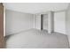 This bedroom features neutral carpet, light gray walls, and a built-in closet, perfect for any decor style at 1548 Longbow Dr, Lakeland, FL 33810
