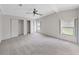 Large bedroom with plush carpeting, ceiling fan, and windows providing natural light at 1548 Longbow Dr, Lakeland, FL 33810