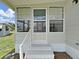 Front porch entrance of the home with stairs and white railing at 1548 Longbow Dr, Lakeland, FL 33810