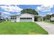 Quaint one-story home features a neatly kept lawn and convenient carport at 1548 Longbow Dr, Lakeland, FL 33810