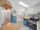 Bright kitchen with wood countertops, white cabinets and unique light fixture at 1548 Longbow Dr, Lakeland, FL 33810