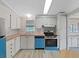 Bright kitchen featuring wood countertops, white cabinetry, and a blue dishwasher at 1548 Longbow Dr, Lakeland, FL 33810