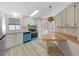 Bright kitchen features wood countertops, white cabinetry, and unique blue dishwasher at 1548 Longbow Dr, Lakeland, FL 33810