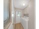 Functional laundry room with washer, dryer, and storage cabinets, next to the door at 1548 Longbow Dr, Lakeland, FL 33810