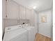 Laundry room featuring a washer, dryer, and ample overhead cabinet storage at 1548 Longbow Dr, Lakeland, FL 33810