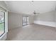 Expansive living area featuring neutral carpet, sliding door to patio, and bright natural light at 1548 Longbow Dr, Lakeland, FL 33810