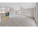Open concept living space with bright kitchen and large carpeted living room with many windows at 1548 Longbow Dr, Lakeland, FL 33810