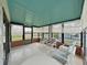 This sunroom offers ample light and seating, creating a relaxing space to enjoy the surrounding views at 1548 Longbow Dr, Lakeland, FL 33810