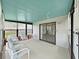 Bright sunroom featuring large windows and comfortable seating, perfect for enjoying the sunlight and outdoor views at 1548 Longbow Dr, Lakeland, FL 33810