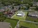 Aerial view showcases the property's layout, with a screened lanai and well-maintained backyard at 165 Lagoon Rd, Winter Haven, FL 33884