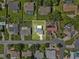 Aerial view of a residential property with a green lawn, surrounded by neighboring homes at 165 Lagoon Rd, Winter Haven, FL 33884
