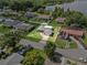Residential property featuring a well-kept lawn, complemented by mature trees and landscaping at 165 Lagoon Rd, Winter Haven, FL 33884