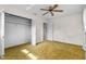 Spacious bedroom with a ceiling fan and a closet with folding doors at 165 Lagoon Rd, Winter Haven, FL 33884
