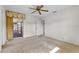 Bright bedroom with neutral walls, sliding glass door access to the lanai, and a ceiling fan at 165 Lagoon Rd, Winter Haven, FL 33884
