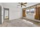Comfortable bedroom features neutral walls, a ceiling fan, and a sunny window, with easy access to the bathroom at 165 Lagoon Rd, Winter Haven, FL 33884