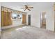 Inviting bedroom with sunny window, ceiling fan, and convenient access to a closet and ensuite bathroom at 165 Lagoon Rd, Winter Haven, FL 33884
