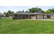 Attractive brick home with a lush green lawn and attached garage at 165 Lagoon Rd, Winter Haven, FL 33884