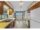 Traditional kitchen with floral wallpaper, yellow countertops, classic cabinets, and plenty of natural light at 165 Lagoon Rd, Winter Haven, FL 33884