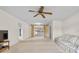 Bright living room features a ceiling fan, neutral walls, and sliding glass doors to the lanai at 165 Lagoon Rd, Winter Haven, FL 33884
