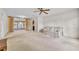 Spacious living room featuring a ceiling fan, chandelier, large sliding glass doors, and comfortable seating at 165 Lagoon Rd, Winter Haven, FL 33884