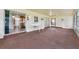 Enclosed sun room with sliding glass doors and neutral carpet. White table and wall sconces included at 165 Lagoon Rd, Winter Haven, FL 33884