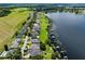 Scenic aerial view of waterfront homes with lush lawns and private docks on the lake at 1836 Woodpointe Dr, Winter Haven, FL 33884