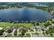 Beautiful aerial view of lakeside homes with lush lawns and docks along the water at 1836 Woodpointe Dr, Winter Haven, FL 33884