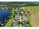 Aerial view of the community with homes, waterfront properties, and natural green spaces at 1836 Woodpointe Dr, Winter Haven, FL 33884