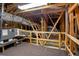 Spacious attic featuring wooden beams, ventilation tubes, and carpet flooring at 1836 Woodpointe Dr, Winter Haven, FL 33884
