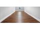 Finished attic with wood flooring, small window, and neutral walls at 1836 Woodpointe Dr, Winter Haven, FL 33884