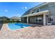 Spacious backyard features a pool, outdoor patio, and well-maintained lawn, ideal for entertaining at 1836 Woodpointe Dr, Winter Haven, FL 33884