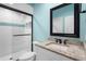 Modern bathroom with granite counters, framed mirror and decorative tile in glass-enclosed shower at 1836 Woodpointe Dr, Winter Haven, FL 33884