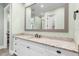 Bathroom with granite countertops, large mirror, white cabinets, and dark bronze fixtures at 1836 Woodpointe Dr, Winter Haven, FL 33884