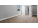Neutral bedroom with a window and view into the ensuite bath and closet at 1836 Woodpointe Dr, Winter Haven, FL 33884