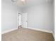 Bedroom with carpet, neutral walls and view into ensuite bathroom at 1836 Woodpointe Dr, Winter Haven, FL 33884