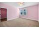 A bedroom featuring neutral carpet, a window with blinds and a walk-in closet at 1836 Woodpointe Dr, Winter Haven, FL 33884