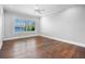 Bright bedroom with hardwood floors and a large window overlooking the lake at 1836 Woodpointe Dr, Winter Haven, FL 33884